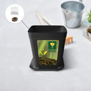 black plastic pot with eco label and plastic bag seed packets on a white surface