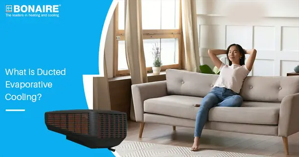 bonaire brand ducted evaporative cooling unit (with greenhouse evaporative pads) in a residential living room, woman relaxing on sofa under cooling vents
