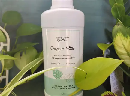 bottle of oxygen plus food grade hydrogen peroxide 3% (garden tool disinfectant) surrounded by green plants; label includes cleaning instructions for plants and home use