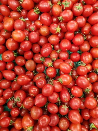 cherry tomato red cluster with ripe, small tomatoes in a pile