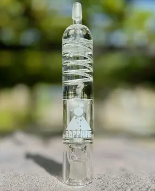 clear dual chamber tumbler glass with spiral coolant chamber and 'sapphire' logo, resting on an outdoor surface