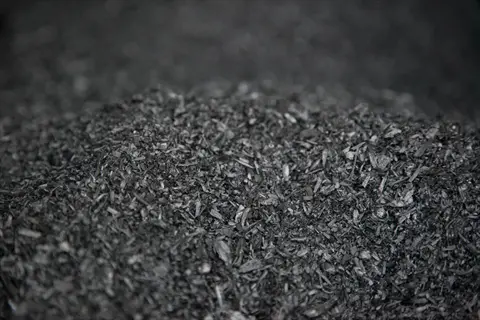 close-up of porous biochar soil amendment fragments with charcoal-like texture and irregular shapes