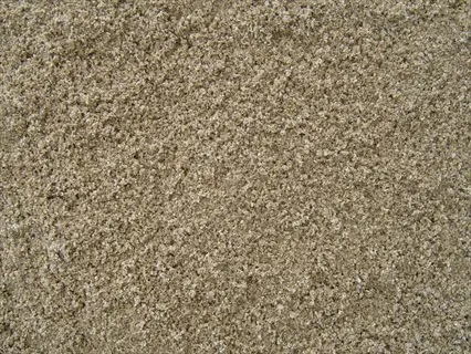 close-up view of coarse horticultural sand with light brown granular texture for soil aeration and drainage