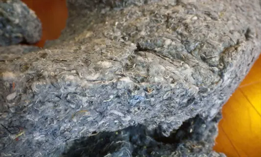 gray fibrous recycled insulation material serving as greenhouse insulation material