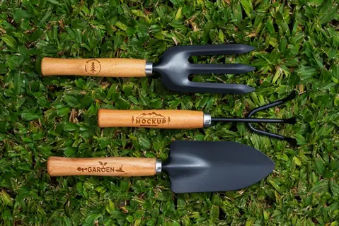 hand trowel garden set with fork and cultivator on grassy background