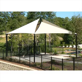 large garden shade cloth structure (30-40% shade) in landscaped area with black fence and trees