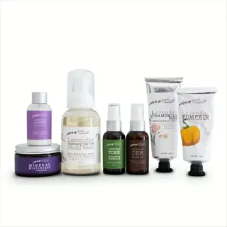 lavender life company skincare products including clear skin treatment oil, facial washes, and moisturizers arranged on white surface