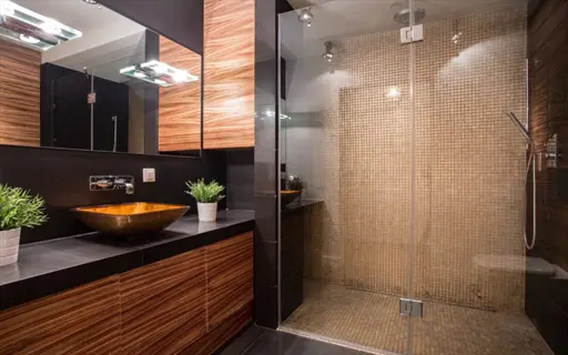modern bathroom toilet fixture: luxury washroom with dual vessel sinks, glass shower enclosure and wooden cabinetry, showcasing watersense toilet upgrades