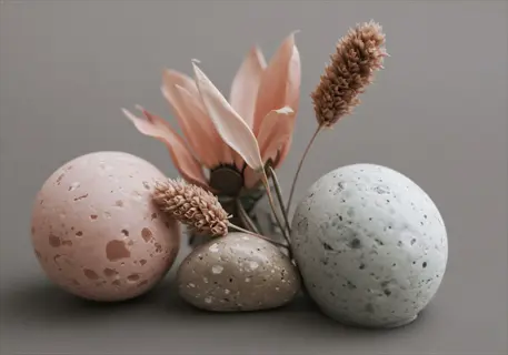 porous calcined clay granules (pink and gray) with dried botanicals and smooth stone, showcasing horticultural use