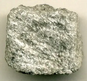 porous pumice volcanic rock fragment, showcasing its light color and airy texture from volcanic origins