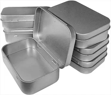 silver metal tins with tight lids for seed storage, some stacked and one open