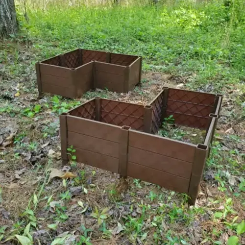two brown raised garden beds in a wooded area with grass and trees, showcasing raised garden bed depth