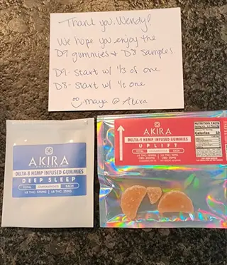 two mylar seed bags (blue 'akira botanicals deep sleep' and holographic 'uplift') with hemp gummies, plus handwritten thank-you note for wendy