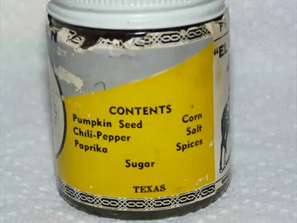 vintage metal seed tin with yellow label listing ingredients: pumpkin seed, chili-pepper, paprika, corn salt, spices, sugar, and 'texas' text