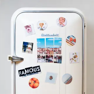 vintage refrigerator decorated with magnetic fridge items including photo magnets (one showing a face), text-based magnets like 'famous', and other decorative pieces
