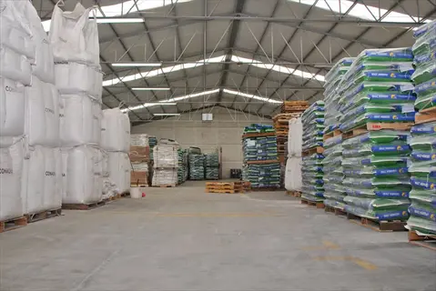 warehouse with stacked mylar seed storage bags and large bags on pallets